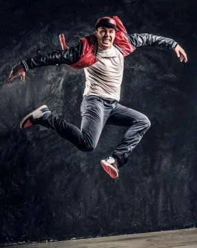 Stylish guy performs breakdance acrobatic elements. Stock Photos