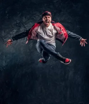 Stylish guy performs breakdance acrobatic elements. Stock Photos