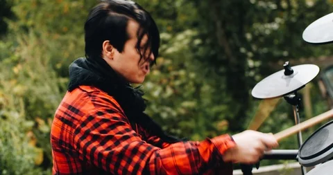 Stylish guy plays electronic drums in the fresh air. Cool footage Stock Footage 114520045