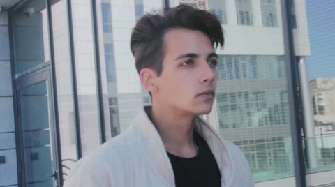 Stylish, handsome guy walking down the street. In the face of a confident look. 動画素材 54684845