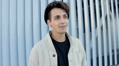 Stylish handsome man in a hat talking on the street. The guy is very charming Видео 54684730