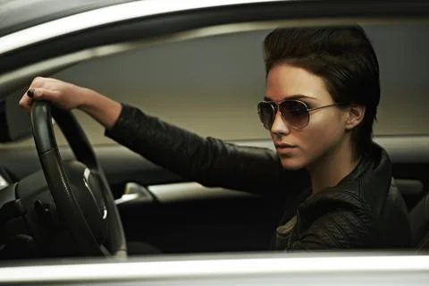 Stylish in her shades and luxury car. A gorgeously stylish woman in shades in Stock Photos