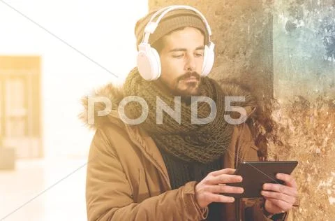 Stylish hipster man using table with a warm tone filter applied Stock Photos