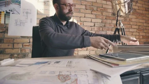 Stylish hipster man working while sitting at a table Stock Footage 73670170