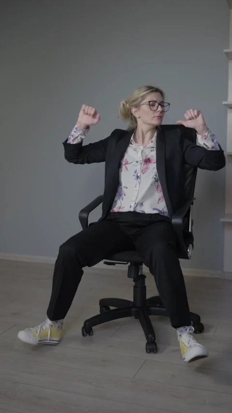 A Stylish Individual Confidently Posing Inside a Modern Office Environment and Stock Footage 306490759