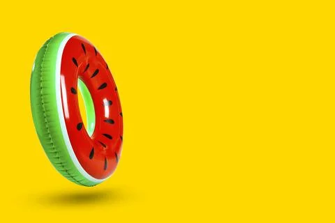Stylish inflatable ring with watermelon pattern in air on orange background.. Stock Photos