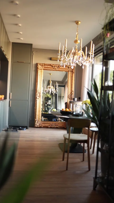 A stylish interior featuring a large ornate mirror, elegant chandelier, and mode Stock Footage 289218919