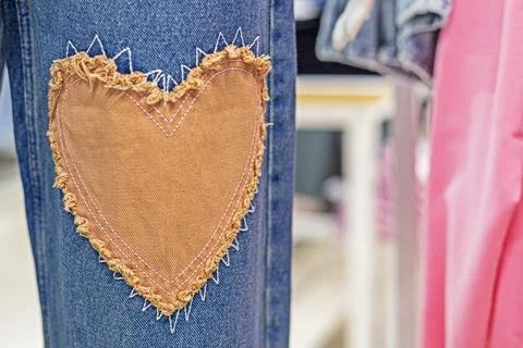 Stylish jeans close-up with a patch in the form of a heart. Fashion and style Fotos de archivo
