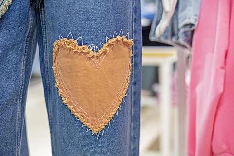 Stylish jeans close-up with a patch in the form of a heart. Fashion and style Fotos de archivo