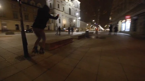 Stylish jumps on inline skates at night Stock Footage 120750071