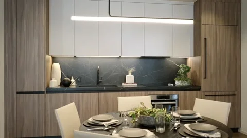Stylish kitchen with brown and white cabinets and built-in oven. Counter and Stock Footage 249520952