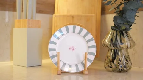 Stylish kitchen decor with elegant plate and vase display Stockbeeldmateriaal 313420507
