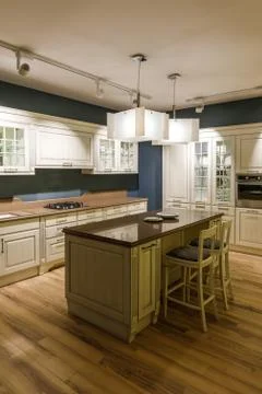Stylish kitchen with elegant shiny table and chandelier Stock Photos