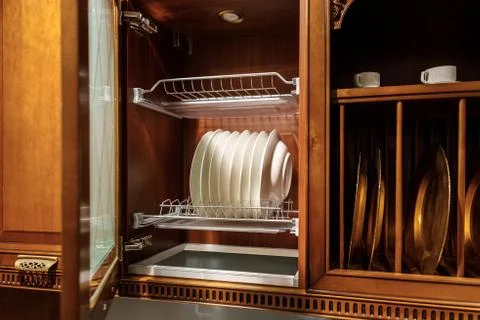 Stylish kitchen with elegant tableware in cupboard Stock Photos