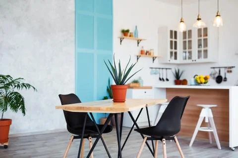 Stylish kitchen interior with dining table and chairs Stock Photos