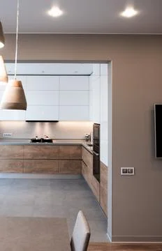 Stylish kitchen interior with dining table, refrigerator, hob, sink and chairs Fotos Stock