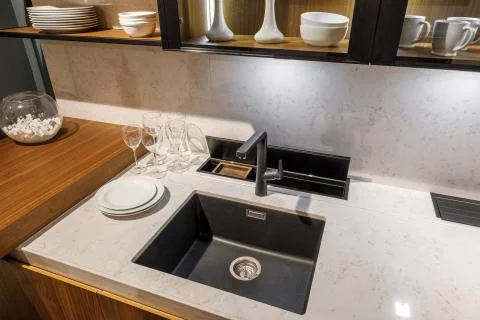 Stylish kitchen with tableware and sink on elegant wooden counter 스톡 사진