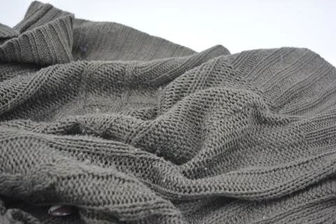 Stylish knitted from brown, woolen thread with an interesting pattern. Stock Photos