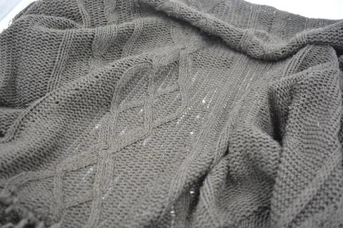 Stylish knitted from brown, woolen thread with an interesting pattern. 写真素材