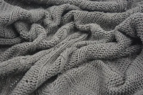 Stylish knitted from brown, woolen thread with an interesting pattern. Stock Photos