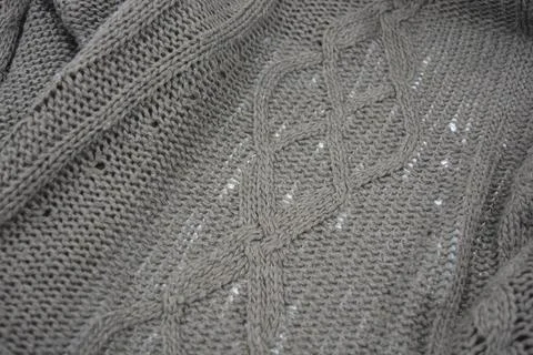 Stylish knitted from brown, woolen thread with an interesting pattern. Stock Photos