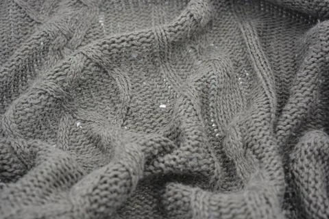Stylish knitted from brown, woolen thread with an interesting pattern. Stock Photos
