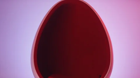 Stylish Lady Entering Studio and Sitting in Egg Chair under Neon Light Stock Footage 121242361