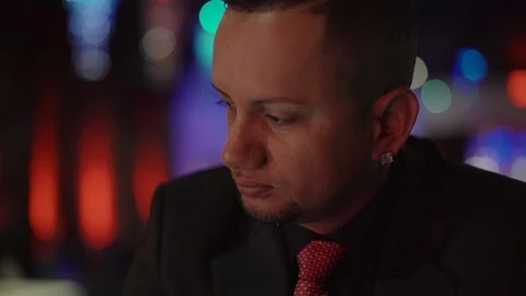 Stylish latin man sitting alone at bar counter with a whisky Stock-Footage 88059953