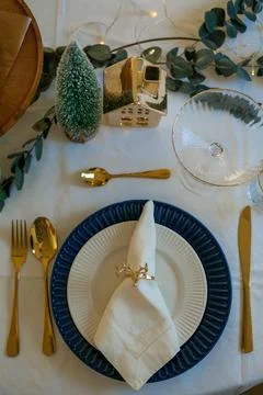 Stylish light Christmas table setting with golden cutlery. Festive feasts. De Stock Photos