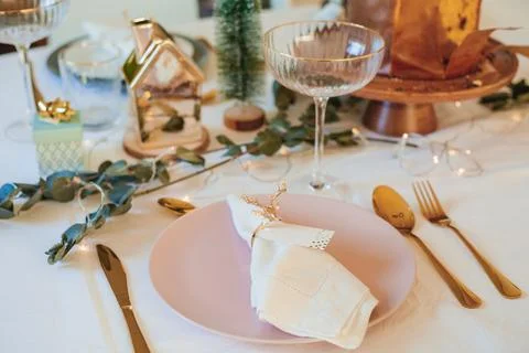 Stylish light Christmas table setting with golden cutlery. Festive feasts. .. Stock Photos