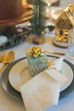 Stylish light Christmas table setting with golden cutlery. Festive feasts. .. Stock Photos