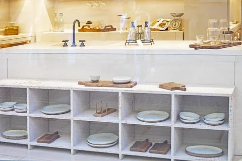Stylish light interior in the kitchen with white modular shelves and dishes Stock Photos