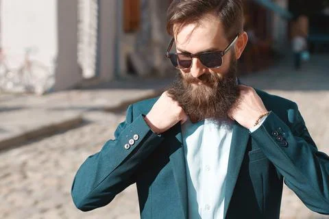 Stylish man with beard wearing a jacket, shirt and bow tie Stock Photos