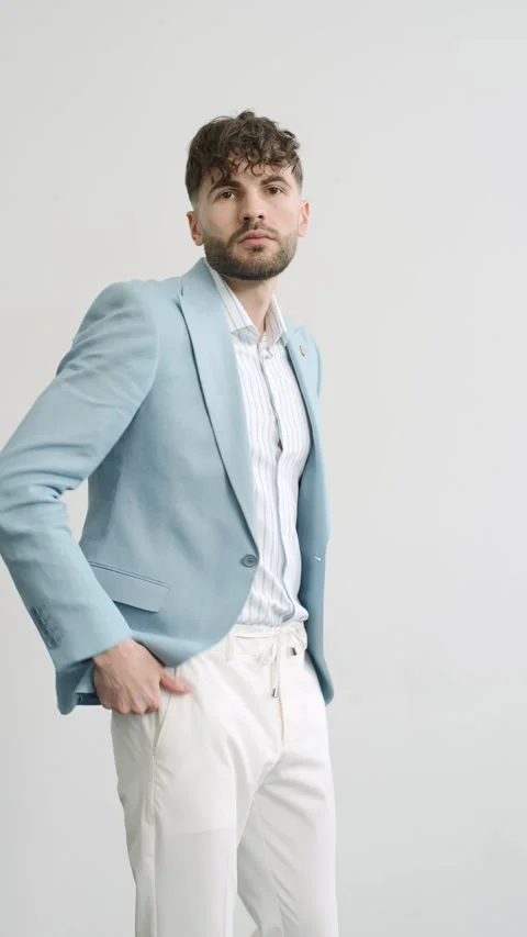 Stylish man in blue jacket and white pants on white background Video stock 277568544