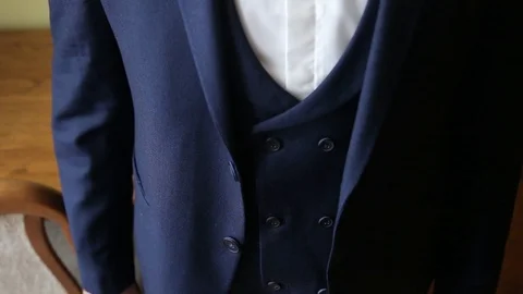 Stylish man buttoning a jacket preparing for going out. Close up. Stock Footage 108556551