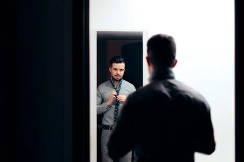 Stylish Man Checking Himself in the Mirror Trying on Clothes Stock Photos