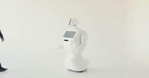 A stylish man communicates with a robot, presses a plastic mechanical arm to the Vídeo Stock 80425378