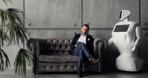 A stylish man communicates with a robot, presses a plastic mechanical arm to the Stock Footage 97967770