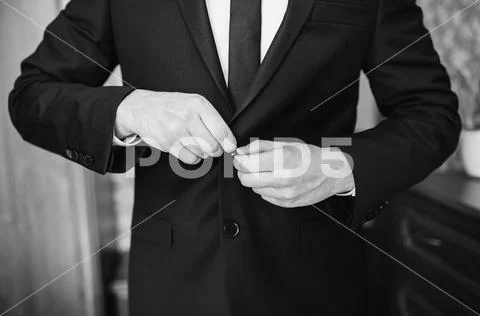 A stylish man in a dark jacket. The businessman in a respectable suit button Stock Photos