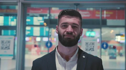 A Stylish Man Dressed in a Modern Suit at an Airport Terminal Ready for His Next Stock Footage 304264948