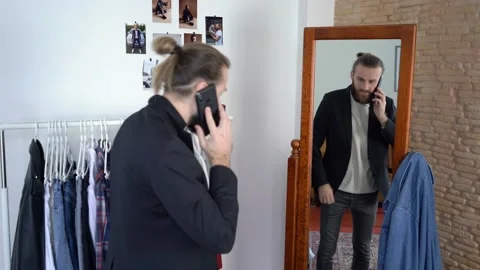 Stylish man  looking in a mirror /  Talking on the smartphone  Wearing Suit Stock Footage 147893042