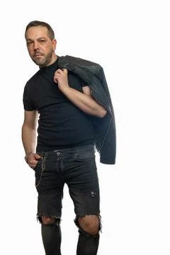 Stylish man posing with leather jacket thrown over Stock Photos