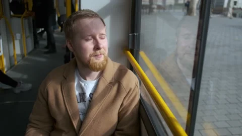 Stylish man rides a tram by the window Stock-Footage 144249944