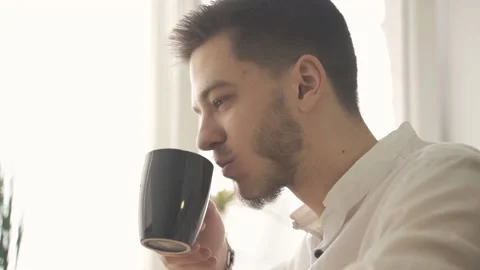 Stylish man sits down at a laptop and starts working Stock Footage 153030882