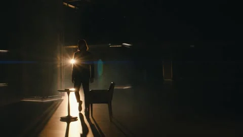 Stylish man sits at a table in an empty hall Stock Footage 141978944