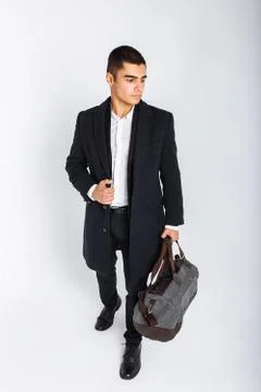 Stylish man in Studio on a white background, with a bag for travel, isolated, Stock Photos