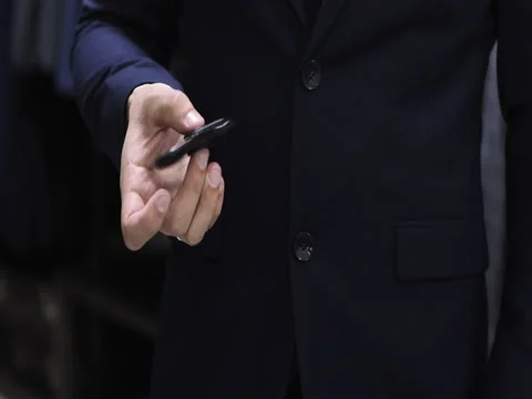 Stylish man in a suit jacket play with hand spinner. Close up Stock Footage 76900424