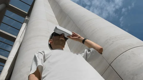 Stylish man uses an VR headset in urban environment outdoors at daytime Stock Footage 170669300
