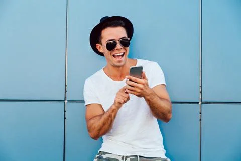 Stylish man using a cell phone outdoors. Stock Photos