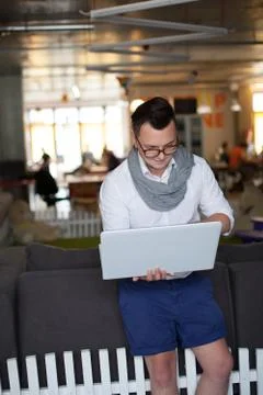 Stylish man using laptop in startup office Stock Photos